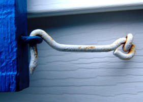Photograph of a rusted window hook